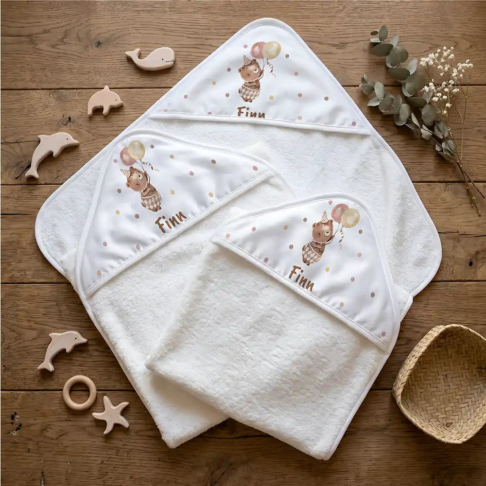 Personalisiertes Kapuzenhandtuch Baby Bär Luftballons – Flatlay mit Eukalyptus und Beißring